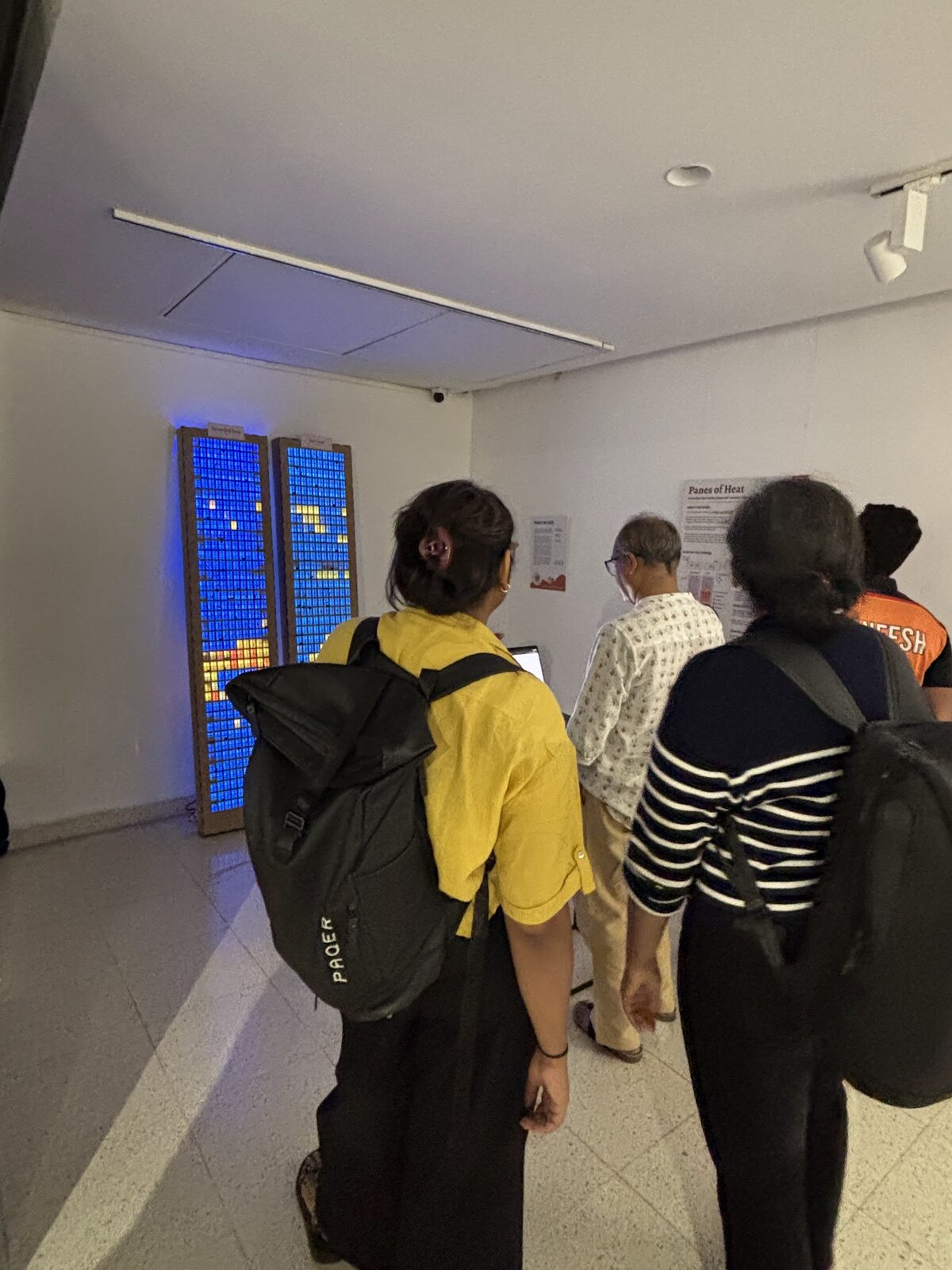 Visitors leaning in to look at the illuminated tower